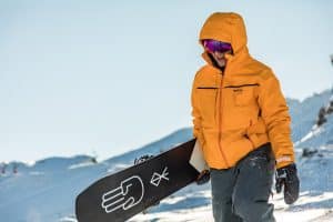 snowboarder carrying board
